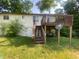 Backyard deck featuring wood steps and satellite dish at 667 E Edgewood Ave, Indianapolis, IN 46227