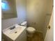Bathroom view with toilet and sink, needing TLC at 667 E Edgewood Ave, Indianapolis, IN 46227