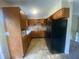 Functional kitchen featuring wood cabinets, linoleum flooring, and a stainless steel refrigerator at 667 E Edgewood Ave, Indianapolis, IN 46227