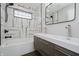 Bathroom with large mirror, stone shower with glass block window and double vanity at 704 Parkway Ave, Indianapolis, IN 46203