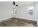 Bedroom with hardwood floors, white trim, and two windows that illuminate the space with natural light at 704 Parkway Ave, Indianapolis, IN 46203