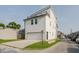 Modern home showcasing white siding and a spacious two car garage at 704 Parkway Ave, Indianapolis, IN 46203