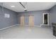 Clean, modern garage with stylish sliding barn doors and a neutral color scheme at 704 Parkway Ave, Indianapolis, IN 46203