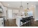 Modern kitchen with white cabinets, a central island with seating, and stainless steel appliances at 704 Parkway Ave, Indianapolis, IN 46203
