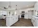 Bright eat-in kitchen featuring white cabinets, a central island, and stainless steel appliances at 704 Parkway Ave, Indianapolis, IN 46203