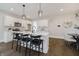 Modern kitchen features white cabinets, a central island with seating, and stainless steel appliances at 704 Parkway Ave, Indianapolis, IN 46203