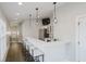 Open-concept kitchen with bar stool seating, stainless steel appliances and modern lighting at 704 Parkway Ave, Indianapolis, IN 46203