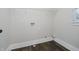 Clean laundry room with white walls, hardwood flooring, and washer/dryer hookups at 704 Parkway Ave, Indianapolis, IN 46203