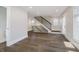 Open living room featuring hardwood floors, modern staircase, and abundant natural light at 704 Parkway Ave, Indianapolis, IN 46203