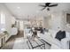 Open-concept living room with an eat-in kitchen, modern furniture, and hardwood floors at 704 Parkway Ave, Indianapolis, IN 46203