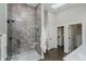 Luxurious main bathroom with a glass-enclosed shower, walk-in closet and modern finishes at 704 Parkway Ave, Indianapolis, IN 46203
