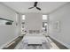 Spacious main bedroom with hardwood floors, ceiling fan, and natural light from multiple windows at 704 Parkway Ave, Indianapolis, IN 46203
