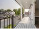 Inviting covered porch with black railing overlooking the neighborhood at 704 Parkway Ave, Indianapolis, IN 46203