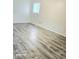 Bright and spacious bedroom with updated flooring and a large window allowing natural light at 731 Sunset Blvd, Greenwood, IN 46142
