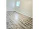 Bright and spacious bedroom with updated flooring and a large window allowing natural light at 731 Sunset Blvd, Greenwood, IN 46142