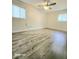 This cozy bedroom features updated flooring, a ceiling fan, and natural light from the windows at 731 Sunset Blvd, Greenwood, IN 46142