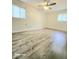 This cozy bedroom features updated flooring, a ceiling fan, and natural light from the windows at 731 Sunset Blvd, Greenwood, IN 46142
