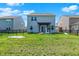 Large backyard showcasing a well-kept lawn, pergola, and secure black fencing surrounding the property at 741 Scarsdale Ln, Danville, IN 46122