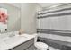 Fresh bathroom with a white vanity, stylish sink, decorative flowers, and a modern shower curtain at 741 Scarsdale Ln, Danville, IN 46122