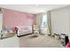 A delightful Bedroom featuring a pink accent wall and plenty of space to play at 741 Scarsdale Ln, Danville, IN 46122