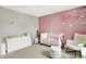 Lovely Bedroom features a pink accent wall, a bassinet, and a rocker at 741 Scarsdale Ln, Danville, IN 46122