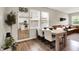 Cozy dining area with a wooden table and chairs, offering a glimpse into the kitchen and living room for seamless entertaining at 741 Scarsdale Ln, Danville, IN 46122