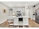 Bright kitchen features an island, stainless steel appliances, modern cabinets, and hardwood floors at 741 Scarsdale Ln, Danville, IN 46122