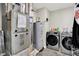 Functional laundry room with modern washer, dryer, water heater, and utility connections at 741 Scarsdale Ln, Danville, IN 46122