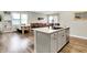 Open concept kitchen and living room with dining table, granite island, hardwood floors, and natural light at 741 Scarsdale Ln, Danville, IN 46122