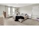Spacious main bedroom with a large bed, hardwood floors, natural light, and a sitting bench at 741 Scarsdale Ln, Danville, IN 46122