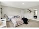 Bright main bedroom with a large bed, hardwood floors, natural light, shelving, and a mirror at 741 Scarsdale Ln, Danville, IN 46122