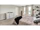 Bright main bedroom with a large bed, hardwood floors, natural light, and a decorative dresser at 741 Scarsdale Ln, Danville, IN 46122