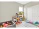 Bright playroom with a playful setup, featuring a ball pit, toy storage, and a whimsical giraffe figure near the window at 741 Scarsdale Ln, Danville, IN 46122