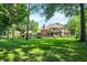 Expansive backyard featuring lush green lawn, mature trees, and a charming gazebo for outdoor relaxation and entertainment at 7648 W Williamswood Dr, New Palestine, IN 46163