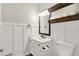 Bathroom featuring a toilet, vanity, framed mirror, and white wainscoting at 7648 W Williamswood Dr, New Palestine, IN 46163