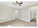 Bedroom with carpet, a ceiling fan, and multiple doorways, offering versatility for living or office use at 7648 W Williamswood Dr, New Palestine, IN 46163
