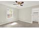 Bright, neutral bedroom with ceiling fan, closet access, large window, and plush carpet at 7648 W Williamswood Dr, New Palestine, IN 46163