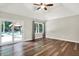 Spacious bedroom with hardwood floors, ceiling fan, tray ceiling and sliding glass doors to outdoor area at 7648 W Williamswood Dr, New Palestine, IN 46163