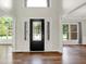 Elegant foyer with hardwood floors, high ceilings, and a decorative front door, creating a welcoming entrance at 7648 W Williamswood Dr, New Palestine, IN 46163
