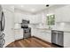 Modern kitchen features stainless steel appliances, white cabinets, granite countertops, and subway tile backsplash at 7648 W Williamswood Dr, New Palestine, IN 46163
