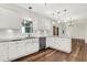 Bright kitchen features white cabinets, subway tile backsplash, stainless steel appliances, and granite countertops at 7648 W Williamswood Dr, New Palestine, IN 46163