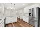 Well-lit kitchen featuring stainless steel appliances, white cabinetry, and granite countertops at 7648 W Williamswood Dr, New Palestine, IN 46163