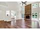 Spacious living room features a brick fireplace, high ceilings, a ceiling fan, and natural light from the outdoors at 7648 W Williamswood Dr, New Palestine, IN 46163