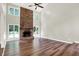 Large living room featuring a brick fireplace, and views of the backyard at 7648 W Williamswood Dr, New Palestine, IN 46163