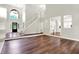 Spacious living area with hardwood floors, a grand staircase, and an open layout, perfect for Gathering gatherings at 7648 W Williamswood Dr, New Palestine, IN 46163