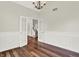 Open-concept living space featuring hardwood floors, wainscoting, and French doors leading to other rooms at 7648 W Williamswood Dr, New Palestine, IN 46163