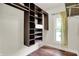 Spacious walk-in closet with adjustable shelving and a built-in drawer, maximizing storage and organization at 7648 W Williamswood Dr, New Palestine, IN 46163