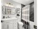 Modern bathroom with a sleek vanity, black marble shower, and neutral striped shower curtain at 7833 Meadow Bend Dr, Indianapolis, IN 46259