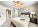 Inviting bedroom with a ceiling fan, large window view, and neutral decor, offering a serene and relaxing atmosphere at 7833 Meadow Bend Dr, Indianapolis, IN 46259