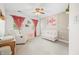 Charming Bedroom featuring a crib, accent wall, and cozy seating area, designed to create a warm and inviting space for a baby at 7833 Meadow Bend Dr, Indianapolis, IN 46259